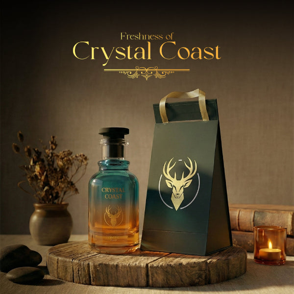 Crystal Coast bottle and packaging on a wooden surface with a candle and plant in the background.